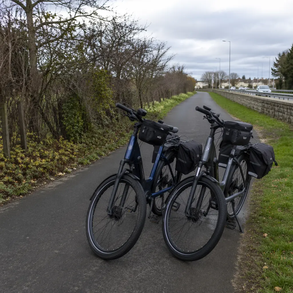 Two electric bikes side by side on a UK cycle path